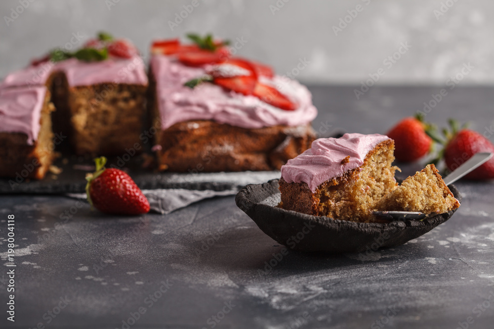 Piece of yogurt pound cake for breakfast with pink glaze and fresh strawberries. Dark background, summer berry dessert, copy space. Piece of yogurt pound cake for breakfast with pink glaze and fresh strawberries. Dark background, summer berry dessert, copy space.