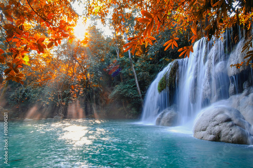Scenic of nature Beautiful Waterfall with sunlight in autumn forest at Erawan  National Park  Thailand  Travel amazing asia