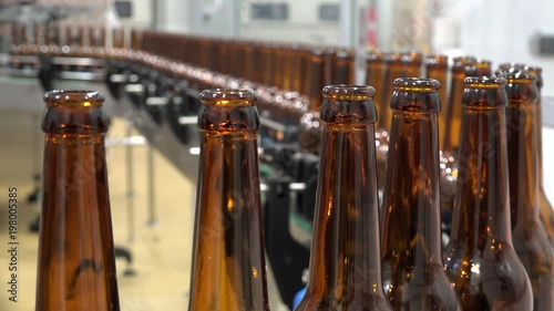 Automatic Beer Bottling Line. Queue of empty bottles on the conveyor. photo