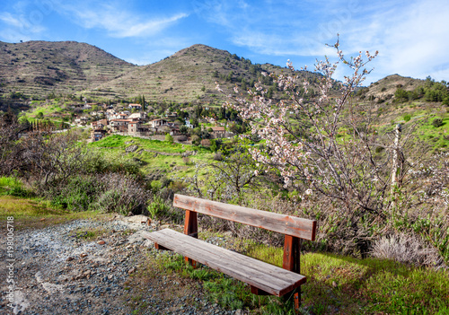 Beautiful spring landscape, a village in the mountains of Cyprus, blue sky, green hills and blossoming almond