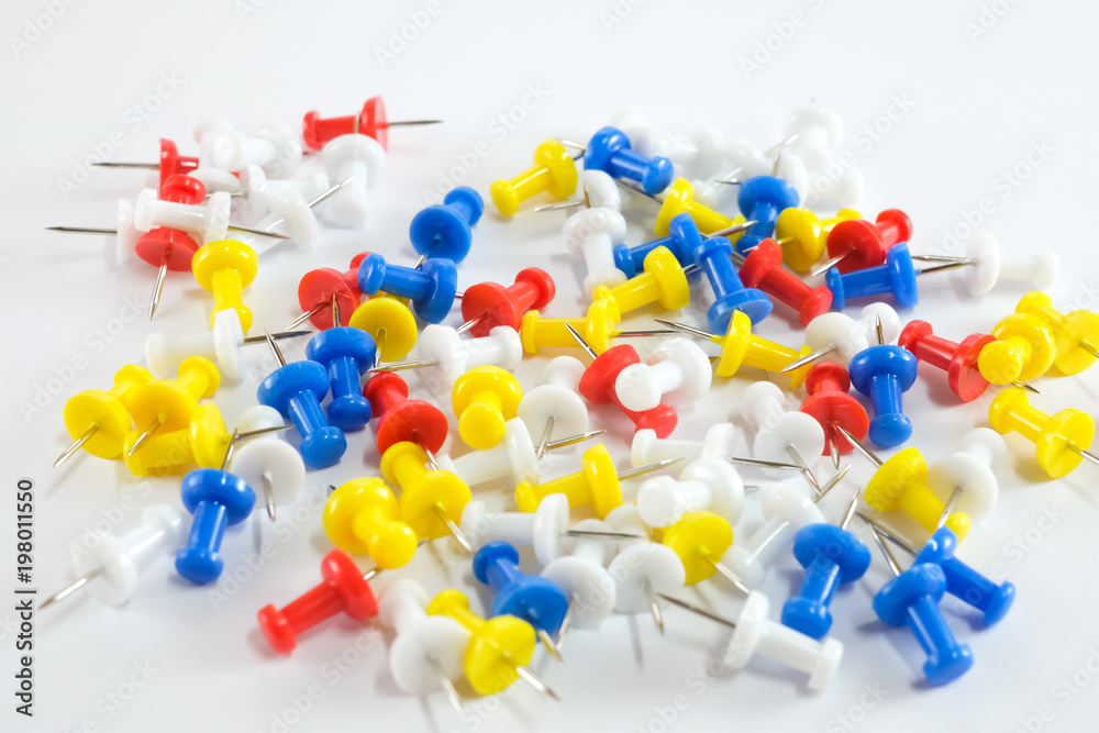 Color push pins red, yellow, white, and blue group on white background Color push pins red, yellow, white, and blue group on white background