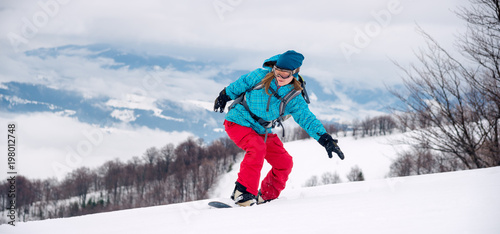 Young woman on the snowboard