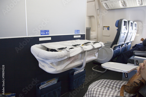 Fotografie Baby sleeping in bassinet on airplane