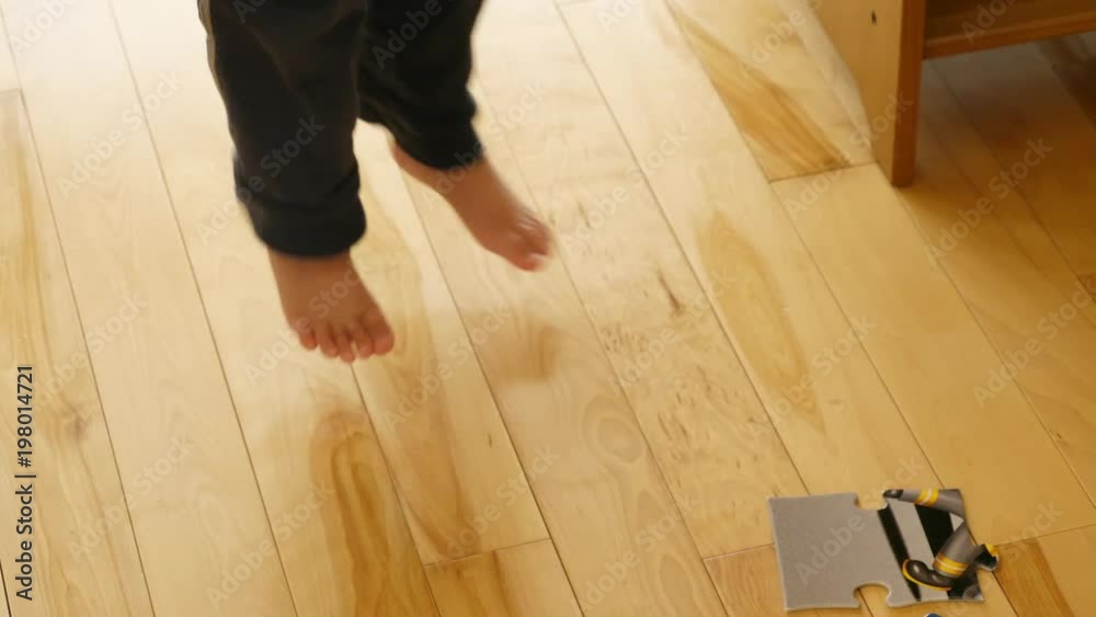 Cute little toddler plays with his puzzle on the floor Cute little toddler plays with his puzzle on the floor