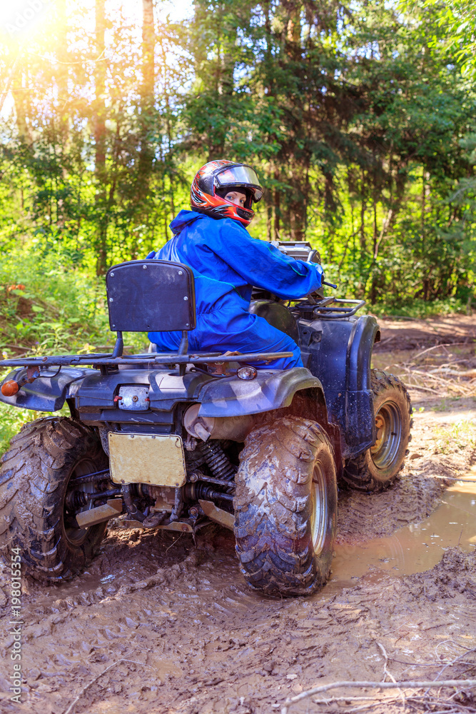 Group of young people riding ATV on dirt track Group of young people riding ATV on dirt track