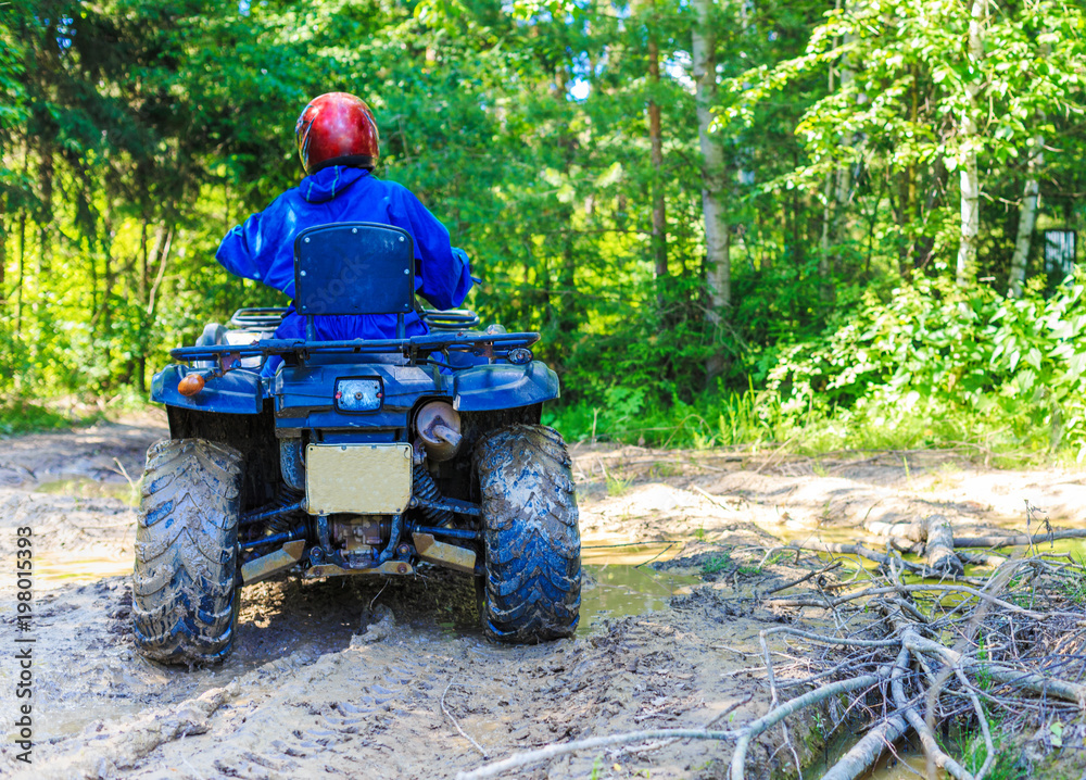 Fototapeta premium Group of young people riding ATV on dirt track
