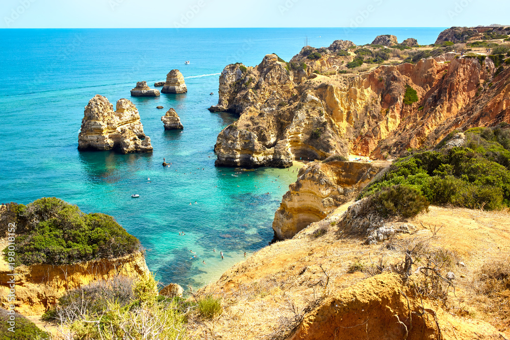 Cliff rocks and sea bay with turquoise water in Lagos, Algarve region, Portugal