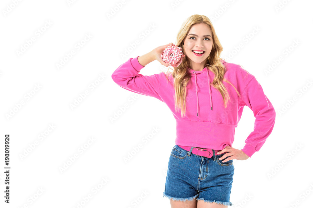 Smiling young girl holding pink doughnut isolated on white Smiling young girl holding pink doughnut isolated on white