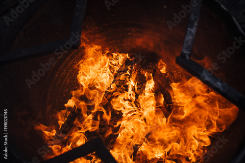 Burning garbage in barrel. Background image of flame. Wood in fire. photo