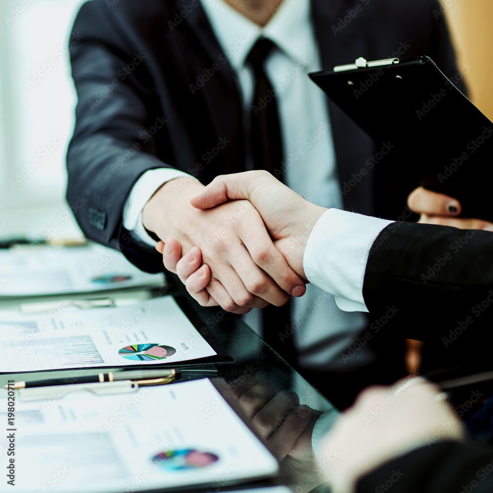 handshake business partners after discussion of the financial agreement