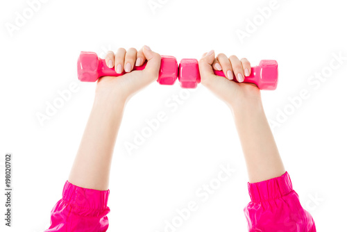 Close-up view of woman lifting pink dumbbells isolated on white