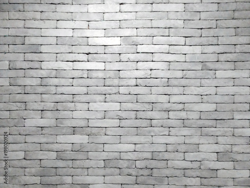 real grey brick wall in blocks with light shining in the center