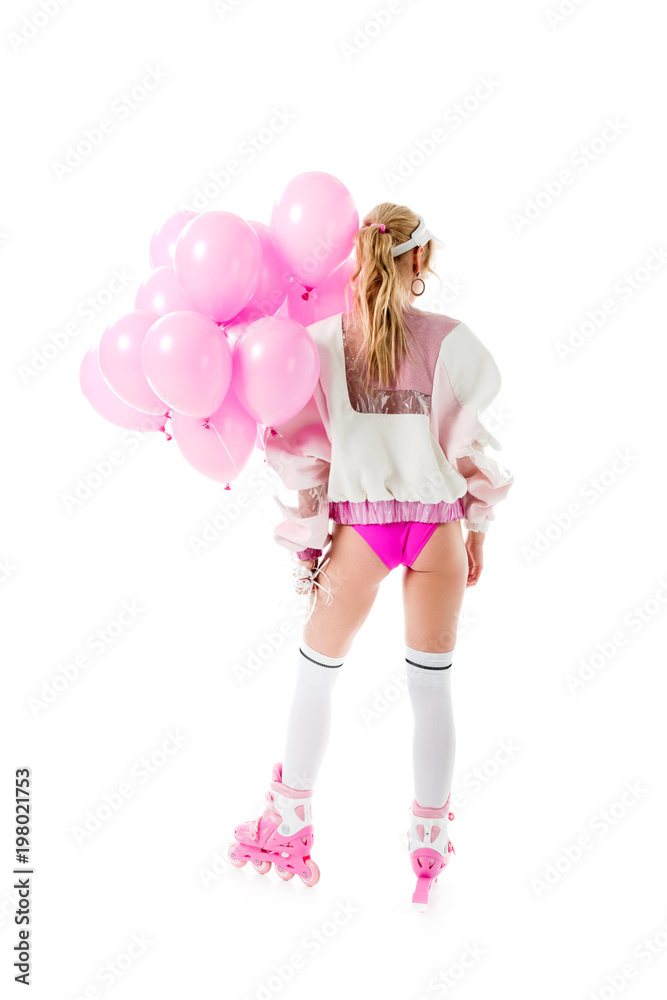 Blonde woman in pink clothes and roller skates holding balloons isolated on white Blonde woman in pink clothes and roller skates holding balloons isolated on white