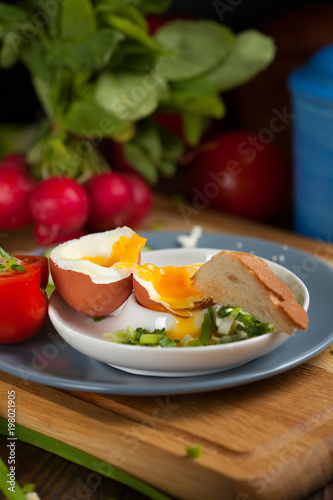 Boiled egg with crunchy bread and healthy vegetables for breakfast