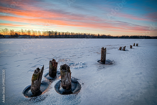 Winter lake sunrise in Sweden photo