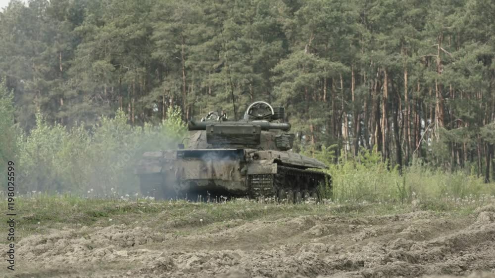 Military Tank In Movement On A Dirt Ground Terrain Military Tank In Movement On A Dirt Ground Terrain