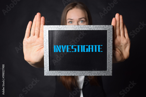 In the hands of a businessman a frame with the inscription:INVESTIGATE © Майя Руднева