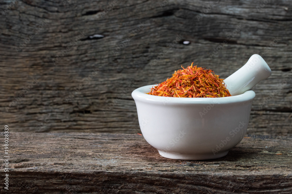safflower mortar on wood table safflower mortar on wood table