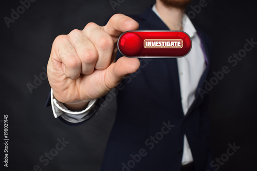 A businessman shows an inscription INVESTIGATE