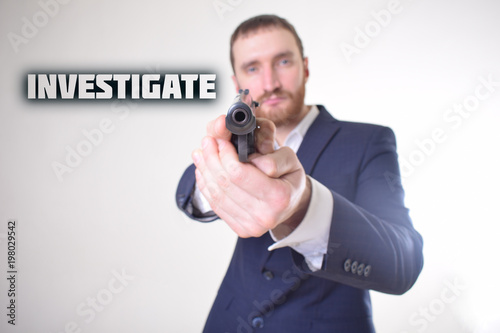 The businessman holds a gun in his hand and shows the inscription:INVESTIGATE