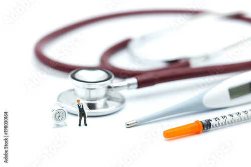 Miniature people: people and doctor standing with stethoscope using for medical or healthcare background concept.