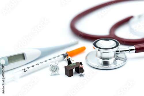 Miniature people: people and doctor standing with stethoscope using for medical or healthcare background concept.