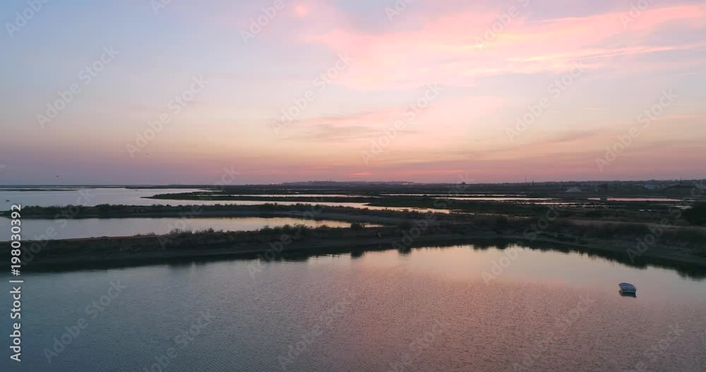 Dusk aerial panoramic seascape view of Olhao salt marsh Inlet, waterfront to Ria Formosa natural park. Portugal. Dusk aerial panoramic seascape view of Olhao salt marsh Inlet, waterfront to Ria Formosa natural park. Portugal.
