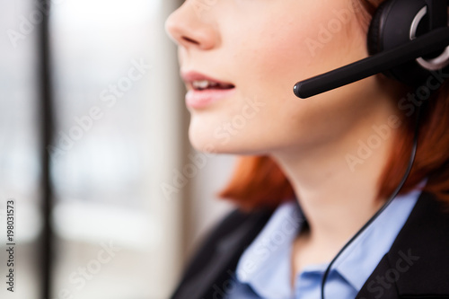 Close up of unrecognisable woman speaking in the headset. Telemarketing and customers support