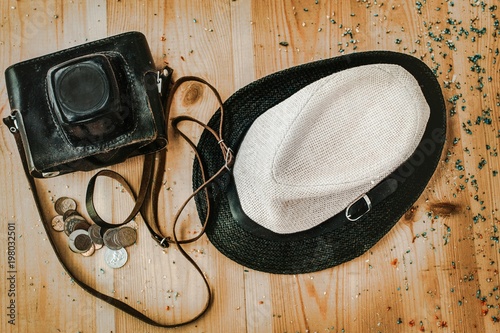 Concept tourism.There is a old photo camera, straw hat and coins