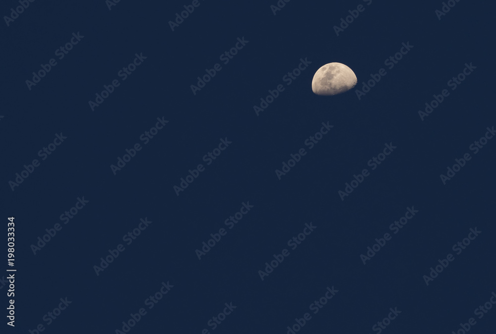 half moon on blue sky no clouds in the evening half moon on blue sky no clouds in the evening