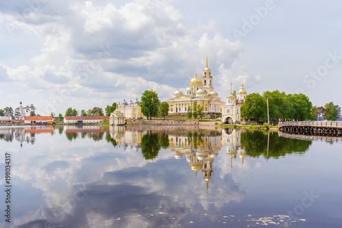 Temples of the Nilo-Stolobenskaya desert with reflection in the lake Seliger