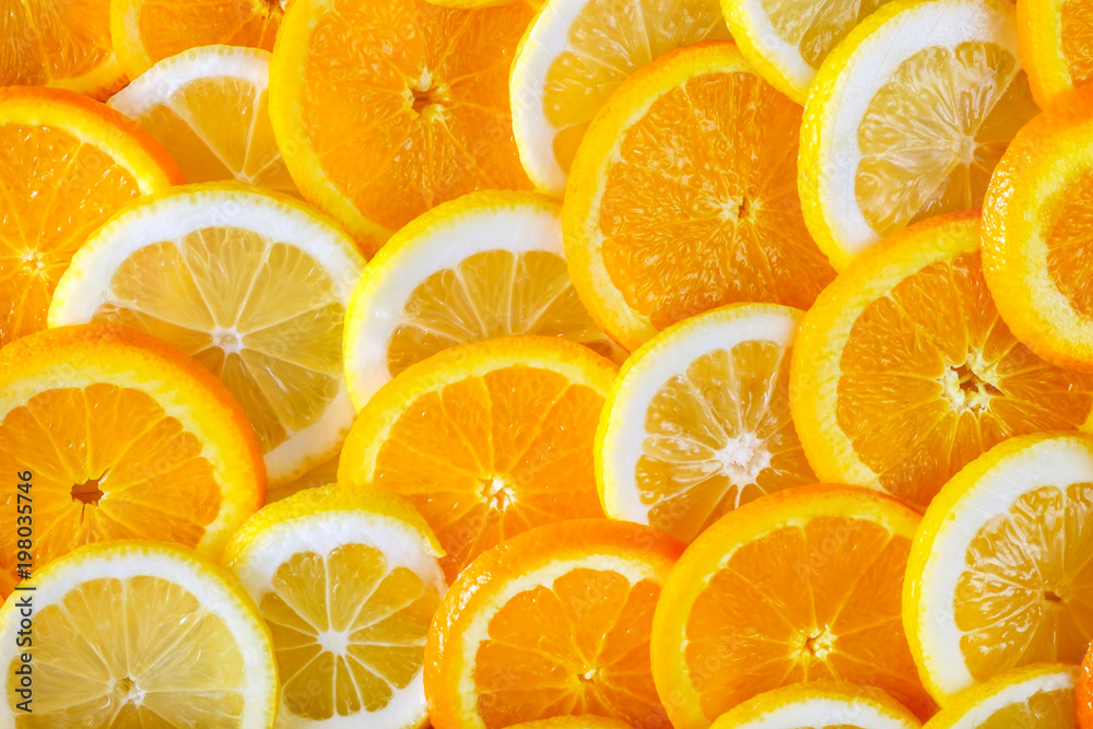 Abstract background of sliced orange and lemon. Close-up view. Abstract background of sliced orange and lemon. Close-up view.