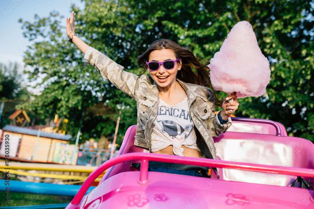 Stylish girl riding a roller coaster at the park Stock Photo Adobe Stock