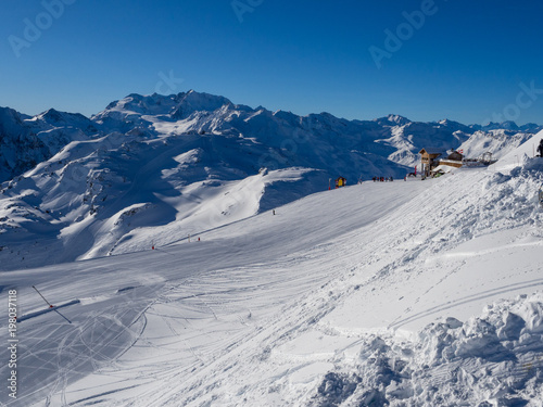 Slope on the skiing resort in Meribel. France, 2018. Blue sky without clouds and white snow. © ikmerc