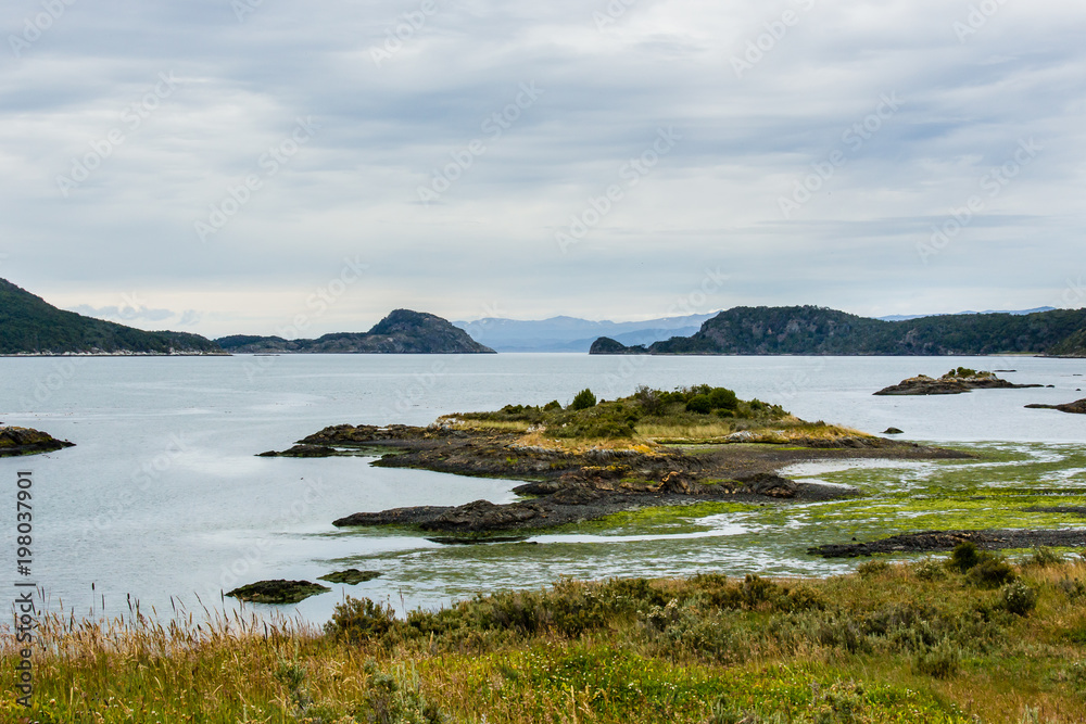lake before mountain range with cloudy skies lake before mountain range with cloudy skies