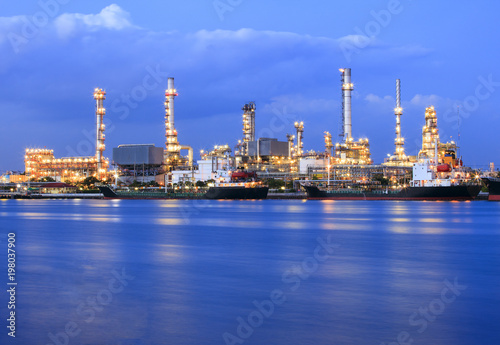 ship port and oil refinery plant with blue river on twilight time