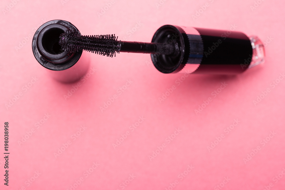 Eyelash makeup brush and mascara bottle close up on pink background with copyspace Eyelash makeup brush and mascara bottle close up on pink background with copyspace
