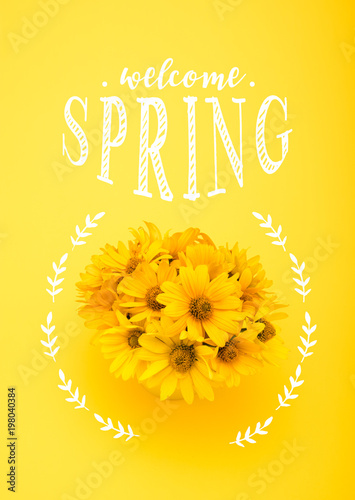 Top view of beautiful chrysanthemum flowers with WELCOME SPRING lettering isolated on yellow