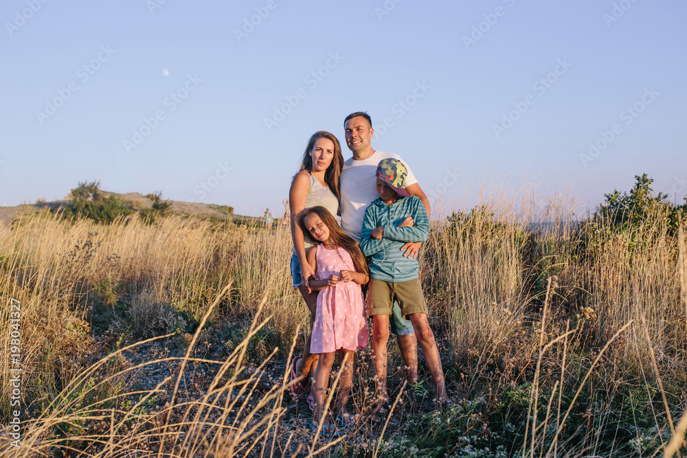 Happy family spending time together outside in field