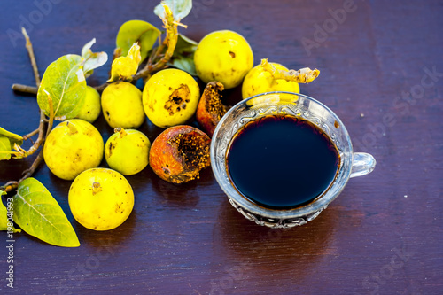 Fresh leaves of Gular,Golar or Clustar Fig tree or Indian Fig tree fruit on a wooden surface with various benefits and its beneficial tea. photo