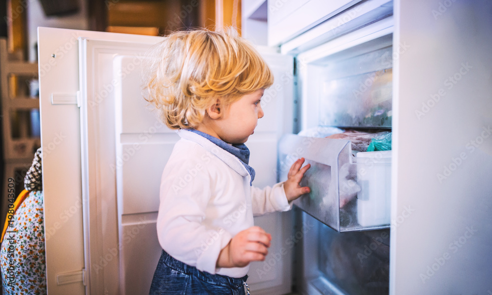 Toddler boy in dangerous situation at home. Child safety concept. Toddler boy in dangerous situation at home. Child safety concept.