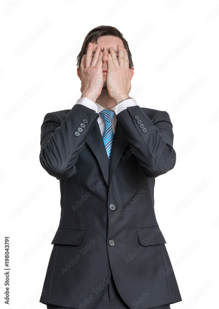Disappointed man is covering his face with hands. Isolated on white background. Disappointed man is covering his face with hands. Isolated on white background.