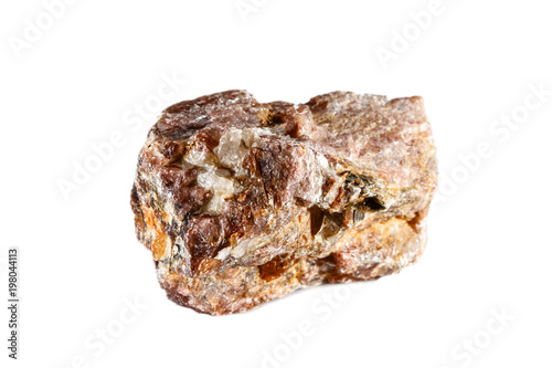 Macro shooting of natural gemstone. The raw mineral is andalusite. China. Isolated object on a white background.