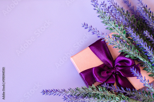 Pink gift box and lavender on violet background