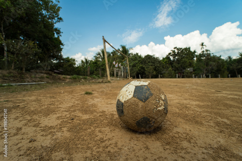 Slika na platnu close up old football on ground at a dirt pitch