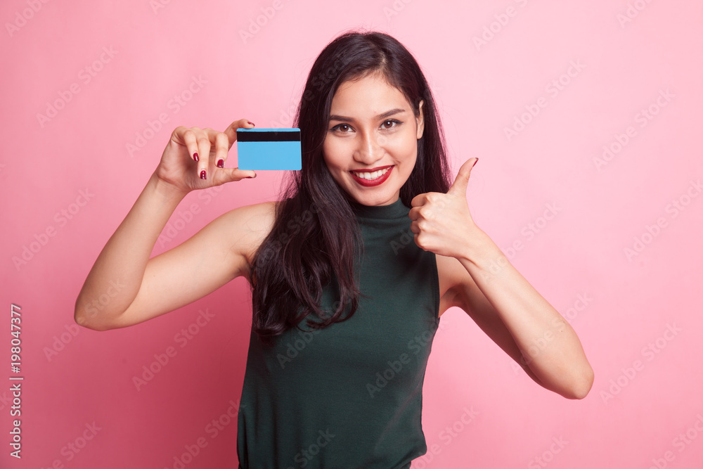 Young Asian woman thumbs up with a blank card.