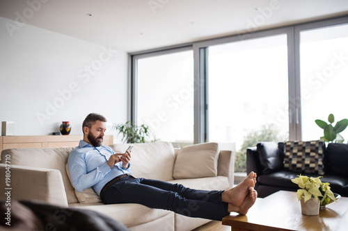 A man holding a smartphone. Smart home.