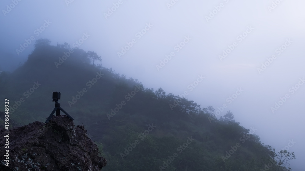 View on mount with fog and action camera on tripod. Making photos in trip or hiking