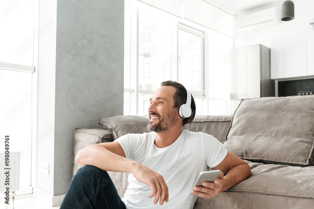 Smiling mature man holding mobile phone Smiling mature man holding mobile phone