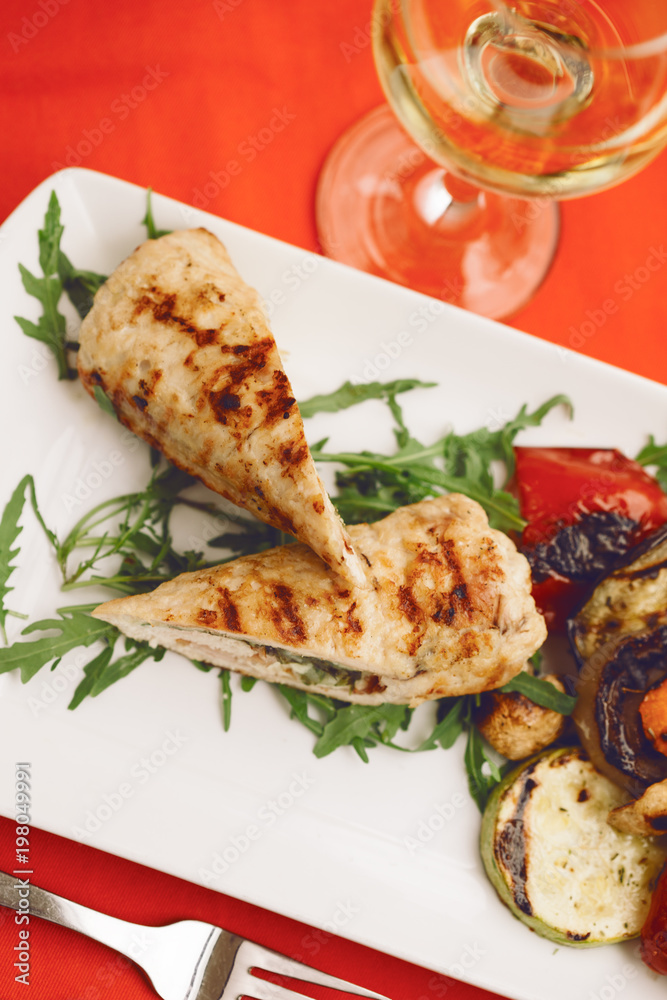 ROLLED CHICKEN WITH BACON served on a table with a glass of wine
ROLLED CHICKEN WITH BACON served on a table with a glass of wine